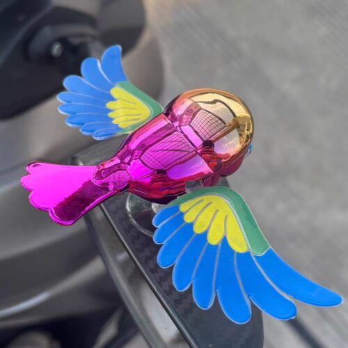Simulated flying bird figurine for electric vehicles