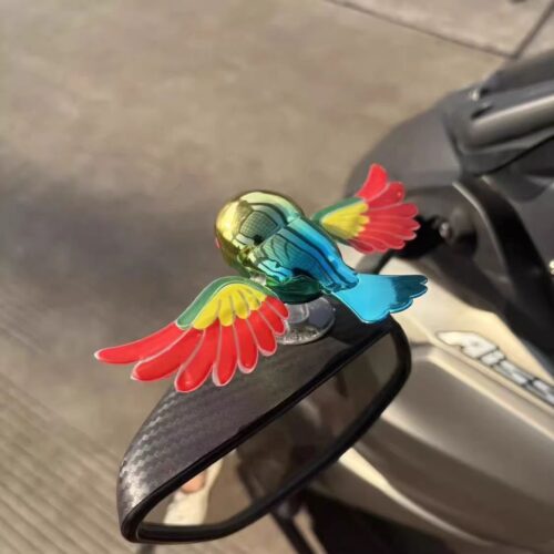 Simulated flying bird figurine for electric vehicles